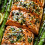 Baked salmon in foil with asparagus and butter, garlic and lemon sauce