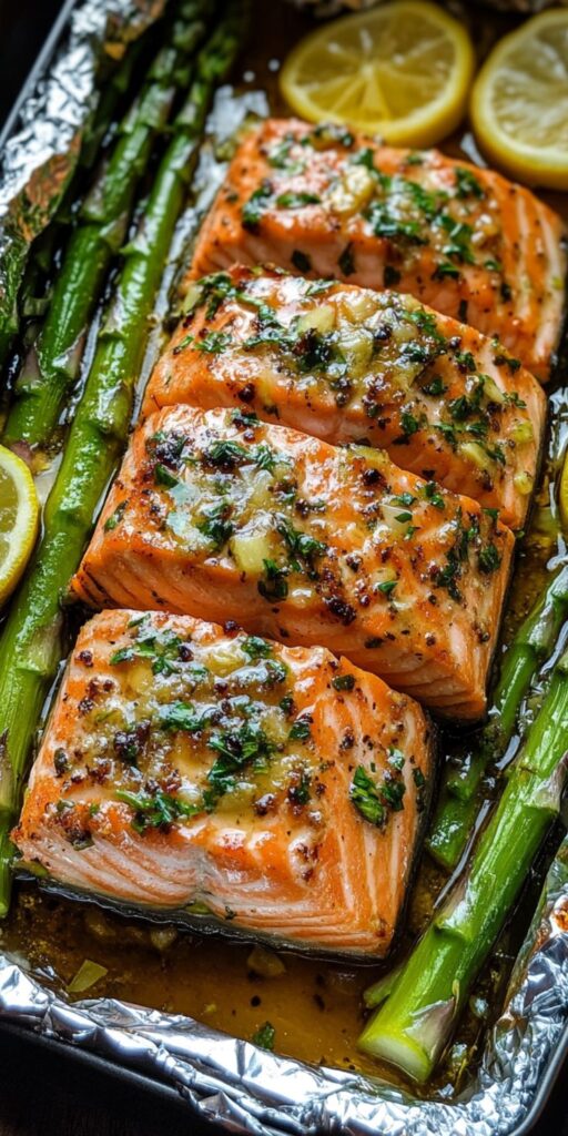 Baked salmon in foil with asparagus and butter, garlic and lemon sauce