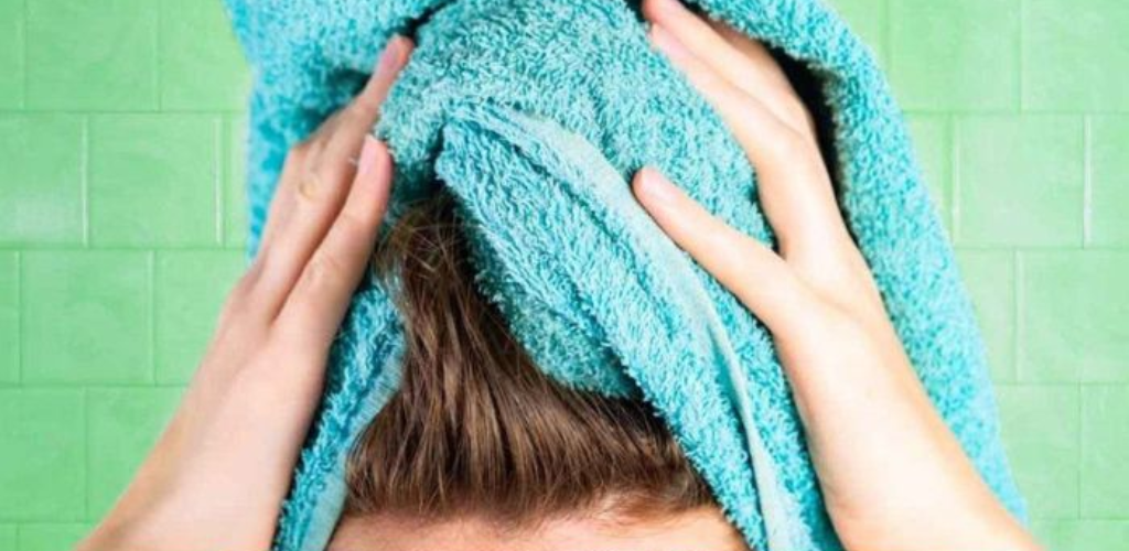 Why is it important not to dry your hair with a cotton towel?